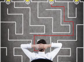 businessman sitting and looking to out of the maze