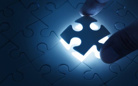 Missing piece Business concept, male hand putting missing piece of jigsaw puzzle with copy space